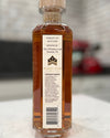 Bottle of whiskey with a label on a marble surface