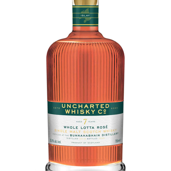 Uncharted Whisky Co. bottle with a green label on a white background