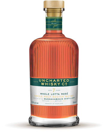 Uncharted Whisky Co. bottle with a green label on a white background